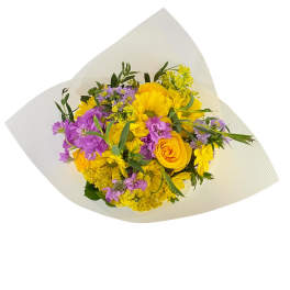 Bouquet of yellow and purple flowers wrapped in white paper