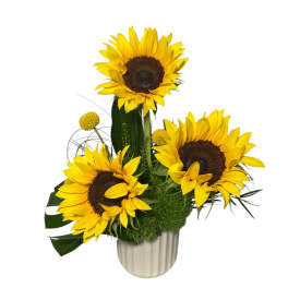 Sunflower arrangement in a ribbed vase