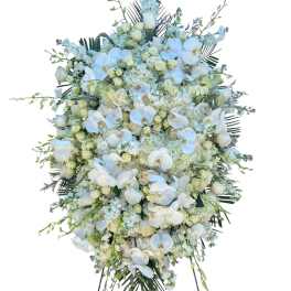 Large white floral standing spray on an easel