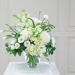 White floral arrangement in a clear glass vase