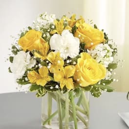 Yellow and white bouquet in a clear glass vase