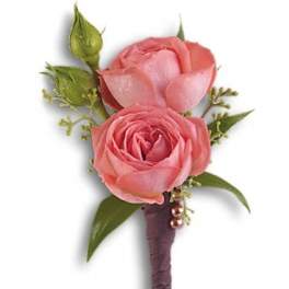 Two pink rose blooms on a wrapped stem boutonniere
