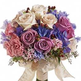 Bouquet of cream, pink, and purple roses with a ribbon wrap