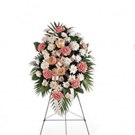 Standing floral spray with pink and white flowers on an easel
