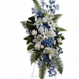 White and blue funeral spray on a standing easel