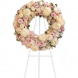 Pastel floral wreath on a white stand
