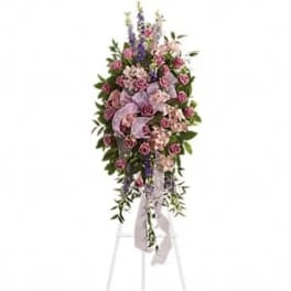 Standing floral spray with pink roses and lavender flowers on an easel
