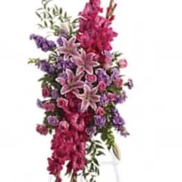 Tall standing floral spray with pink lilies and purple flowers