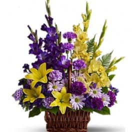 Basket arrangement of purple and yellow flowers