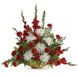 Red roses and white spider mums in a wicker basket