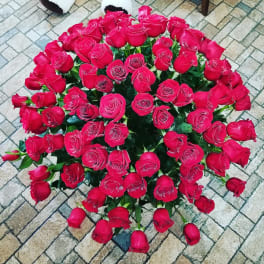 Large bouquet of red roses arranged in a round cluster