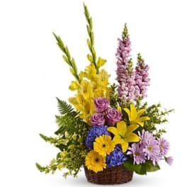 Colorful mixed flower arrangement in a wicker basket
