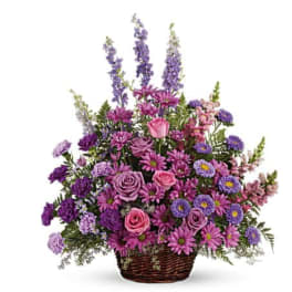 Basket arrangement of pink and purple flowers with tall lavender spikes