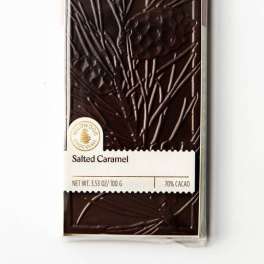Bar of dark chocolate in a clear wrapper labeled salted caramel