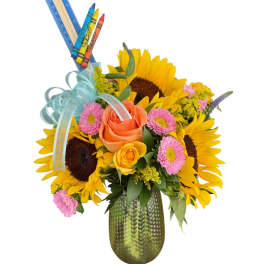 Sunflower and rose bouquet in a green vase with crayons and ruler