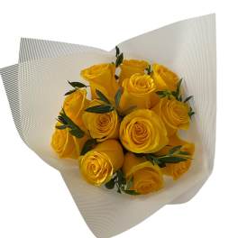 Bouquet of yellow roses wrapped in white paper