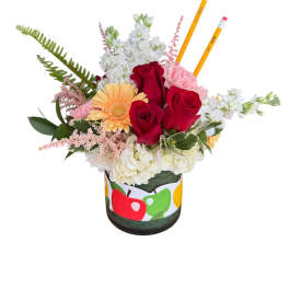 Bouquet of red roses, white blooms, and a peach gerbera in a decorated container with pencils