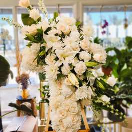 Large white floral standing spray on an easel