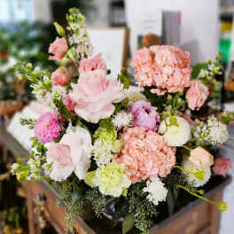 Pink and white mixed bouquet with hydrangeas, roses, and other blooms