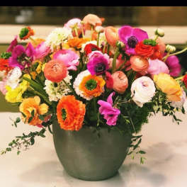 Colorful mixed flower arrangement in a green vase