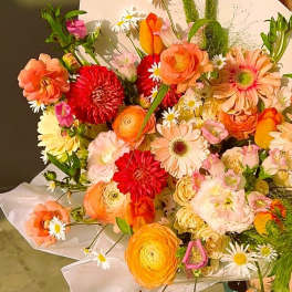 Bright mixed bouquet with orange, pink, red, and white flowers