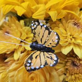 Yellow flower bouquet with a decorative butterfly pick