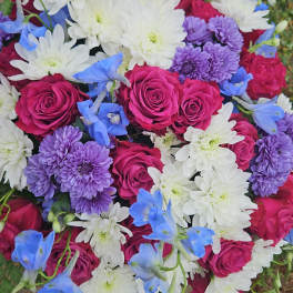 Bouquet of pink roses, white daisies, purple mums, and blue flowers