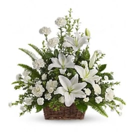 White lilies and carnations in a wicker basket