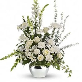 White floral arrangement in a silver vase with tall stems