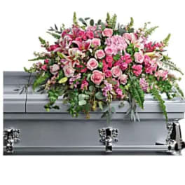 Pink floral spray on a silver casket