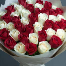 Bouquet of red and white roses wrapped in paper