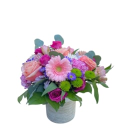 Pink and purple mixed bouquet in a gray vase