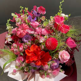 Bright mixed bouquet of pink, red, purple, and white flowers