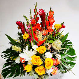 Large tropical bouquet with yellow roses, white lilies, and red-orange blooms