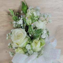 White rose bouquet with baby's breath and a large sheer ribbon