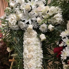 White floral standing cross arrangement with roses and lilies