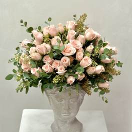 Pink rose bouquet in a sculpted gray vase