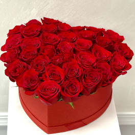 Heart-shaped box filled with red roses