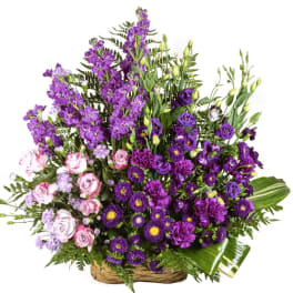 Large basket arrangement of purple and pink flowers