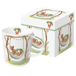 White mug with a bunny in a hammock and carrots, shown with a matching illustrated gift box.