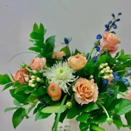 Peach roses and white chrysanthemum bouquet with blue accents
