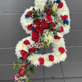 Floral standing spray in the shape of a number 4 with red, white, and blue flowers