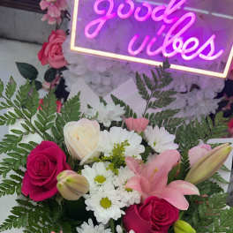 Bouquet of pink and white roses, lilies, and daisies