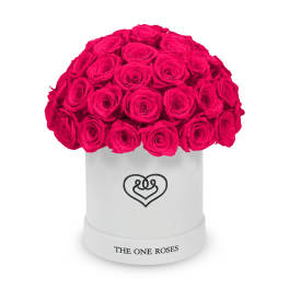 Hot pink roses arranged in a white round box