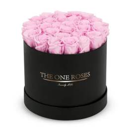 Pink roses arranged in a black round box