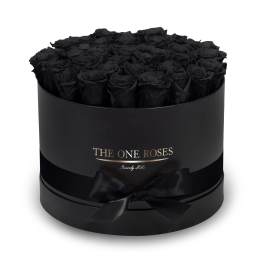 Black roses in a round black gift box with a ribbon