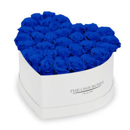 Blue roses arranged in a white heart-shaped box