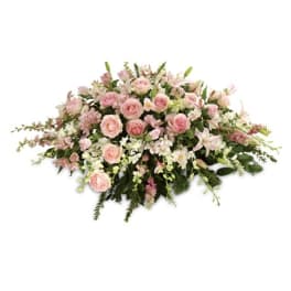 Low floral spray of pink roses and white lilies