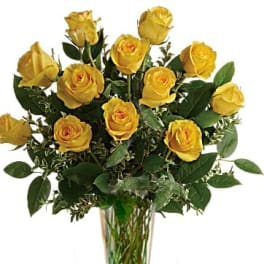Yellow roses arranged in a clear glass vase