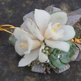 White calla lily corsage with silver ribbon and green accents